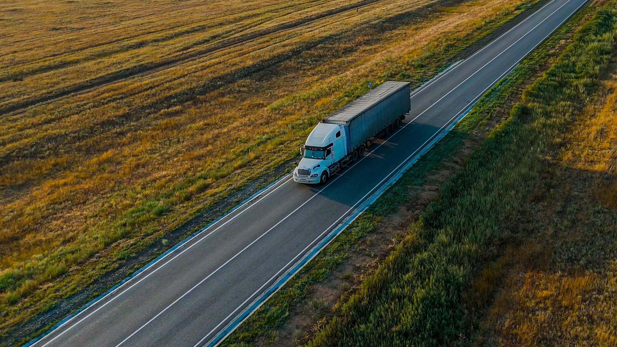 Aerial view of a highway crossing open farmland