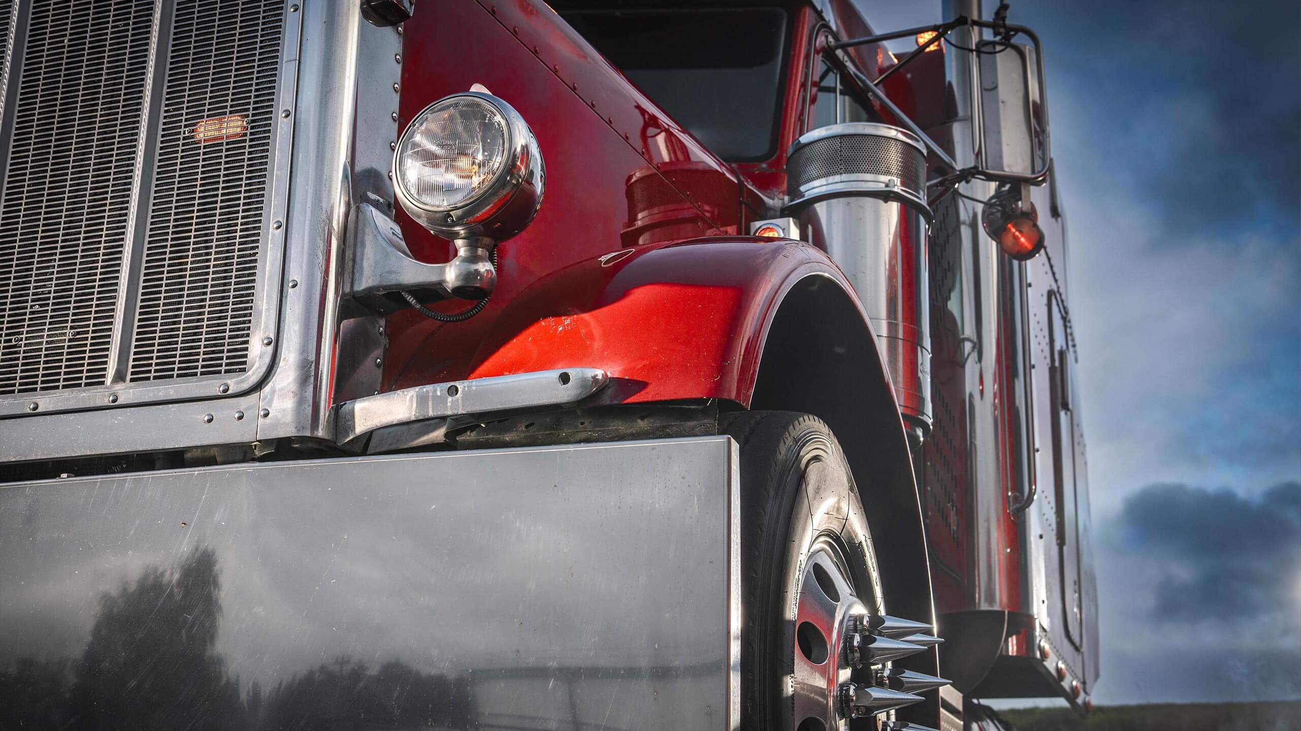 Chrome grille of a red semi truck